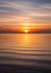 Obraz premium Serene Sunset Over Calm Ocean Waters