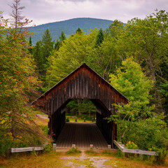Photo Caption: The Historic Bennett Bean Covered Bridge in Lincoln Plantation, Maine, built in...