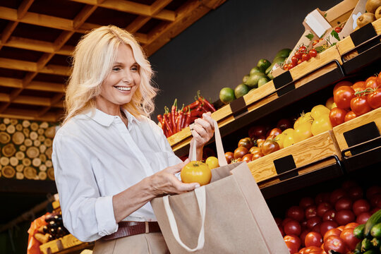 Blonde woman selects organic fruits at a vibrant local grocery store