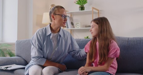 During a quiet psychologist therapy session at home, a counselor rests a hand on a child’s shoulder, modeling empathy, caring support, and open communication. Counselor and child build trust together