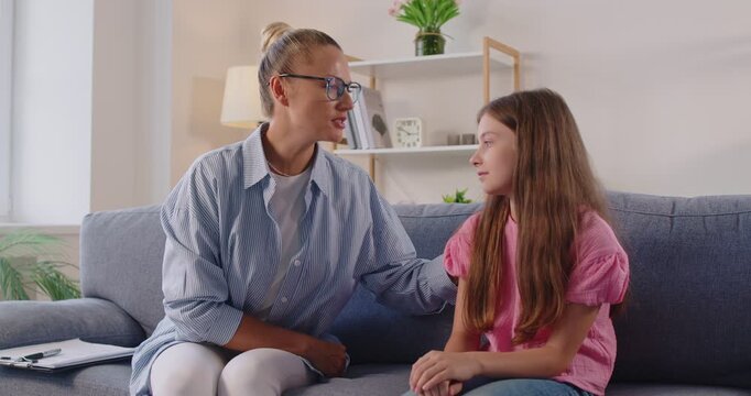 During a quiet psychologist therapy session at home, a counselor rests a hand on a child’s shoulder, modeling empathy, caring support, and open communication. Counselor and child build trust together