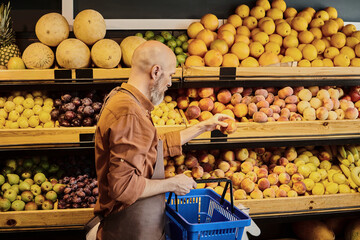 Salesman engages with fresh organic produce at a vibrant farmers market store