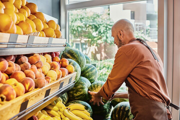 Fresh organic produce at a farmers market with a helpful salesman