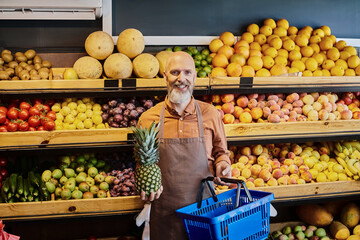 Smiling salesman showcases fresh organic produce at a vibrant grocery store