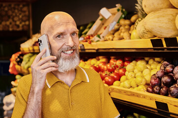 Man enjoys conversation while purchasing fresh organic produce at local farmers market