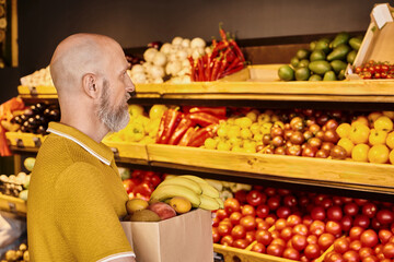 Man purchases fresh organic produce at a local farmers market grocery store