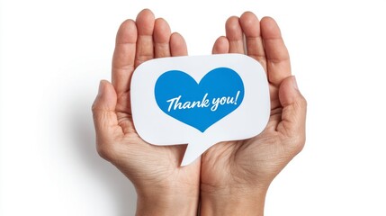 Hands holding a speech bubble with a blue heart and text expressing gratitude in a minimalistic setting