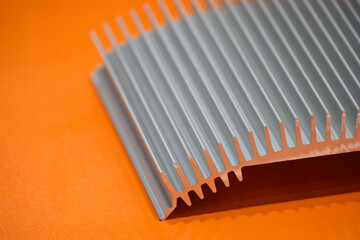 The aluminum heat sink parts on the orange background.
