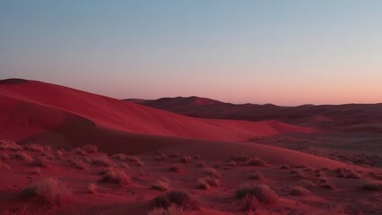 Naklejka premium Sunset Over Red Sand Dunes in a Desert Landscape