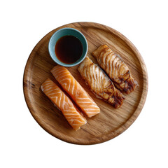 Delicious assortment of salmon sushi garnished with soy sauce in a small dish, beautifully presented on a round wooden plate.