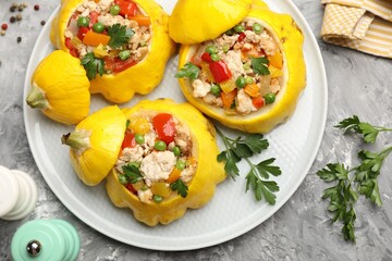 Tasty stuffed pattypan squashes and spices on grey textured table, flat lay
