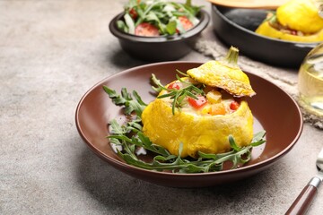 Tasty stuffed pattypan squash with arugula served on grey table, closeup