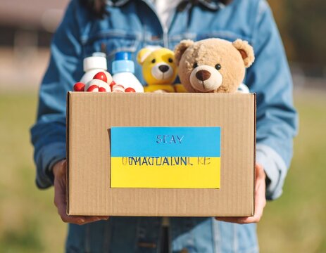 Holding a box with Ukrainian flag donation support and humanitarian aid in times of conflict to