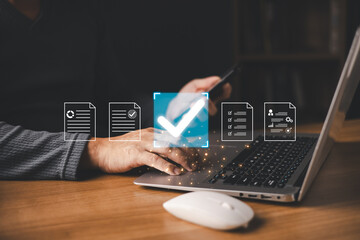 A person using a laptop and smartphone interacts with glowing digital icons of documents and a large checkmark, symbolizing document approval, verification, and secure online processing.