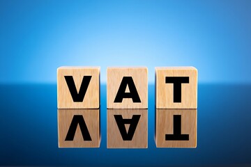 V A T Acronym Wooden Blocks Blue Background Reflection