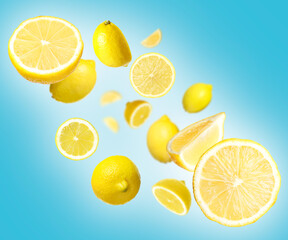Fresh ripe lemons swirling in air against blue gradient background