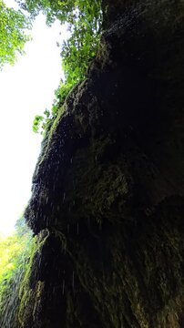 Beautiful slow motion video of the Sipote Waterfall (Cascadele de travertin) on a beautiful sunny summer day. Rain like water droplets falling from the travertine rocks giving a zen vibe. Alba,Romania