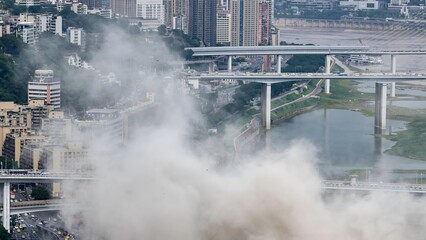 Foggy Chongqing bridges and cityscape shrouded in mist, China urban landscape with dramatic...