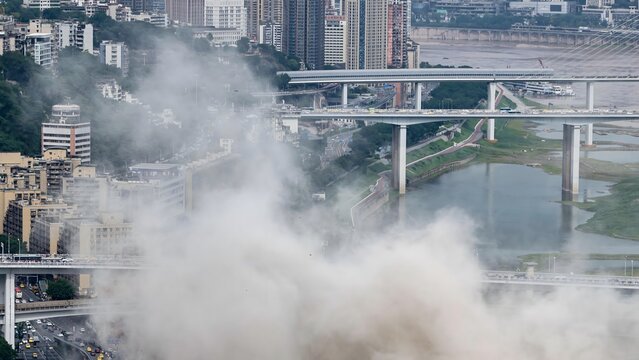 Foggy Chongqing bridges and cityscape shrouded in mist, China urban landscape with dramatic atmospheric conditions