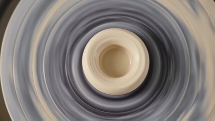 Pottery wheel spinning, shaping clay into a vase, close-up ceramic artistry in motion, focusing on