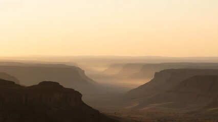 Naklejka premium Sunrise Over a Vast Canyon with Hazy Horizon
