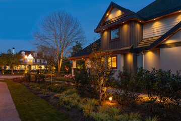 Two story stucco luxury house with nice Spring blossom landscape at night in Vancouver, Canada, North America. May 2025.