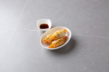 3 fried dumplings and soy sauce 군만두 3개와 간장