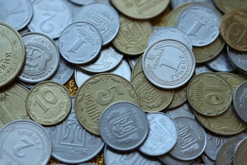 Metal coins of Ukraine of different denominations are scattered. Money texture, business background.