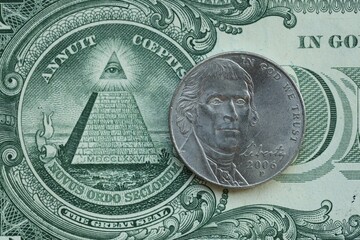 American cent coin on dollar bill close up. United States currency