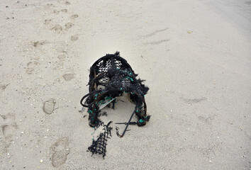 Tattered Lobster Pot Abandoned on a Beach
