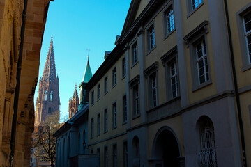 View from a side street of the Freiburg Minster illuminated by the evening sun