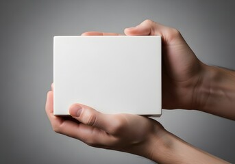 Fototapeta premium Two Hands Holding a Blank White Box - Mockup for Product Presentation