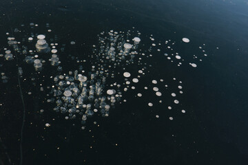 Obraz premium Ice ax - ice screws on winter fishing on the ice caves. Ice is very clean and beautiful. The Lake Baikal.