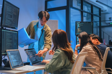 Young Asian man software developers mentor leader manager Verification and validation in software...