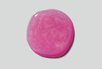 Cosmetic fuchsia shimmering drop sample. Lip gloss or mask textured swatch drop.