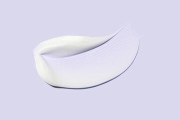 Liquid white cream balm mask cosmetic smudge texture isolated on purple lilac background