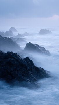 Misty sea stacks at dawn create eerie atmosphere