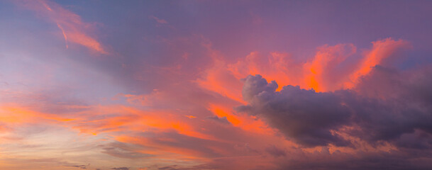Fototapeta premium Aerial view amazing colorful pink sky in twilight above the ocean. romantic colorful sunrise scene with a bright colorful sky gradually turning into a dark night. Sky texture background.