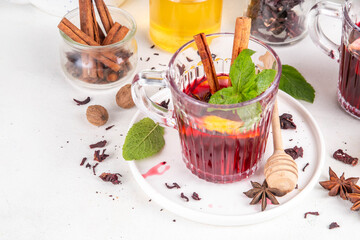 Tasty autumn non-alcohol hibiscus mulled wine drink. Autumn winter alcohol free mocktail alternative for adult and kids, made on hibiscus flower tea, with cinnamon, lemon and mulled wine spices