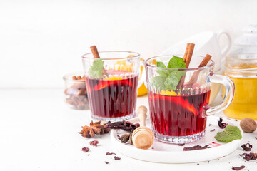 Tasty autumn non-alcohol hibiscus mulled wine drink. Autumn winter alcohol free mocktail alternative for adult and kids, made on hibiscus flower tea, with cinnamon, lemon and mulled wine spices