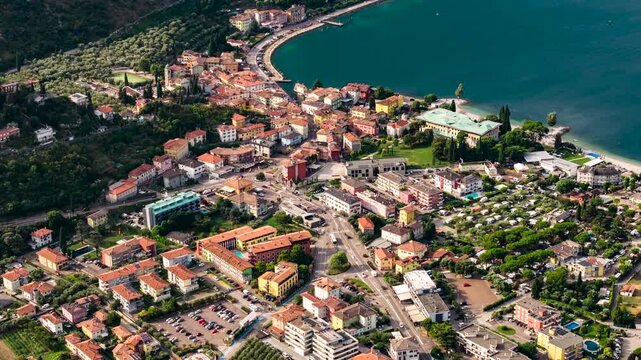 Orbital hyperlapse of Torbole town center with fast moving traffic, Lake Garda, Italy