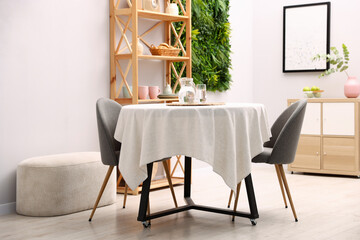 Stylish table with chairs and decor in dining room. Interior design