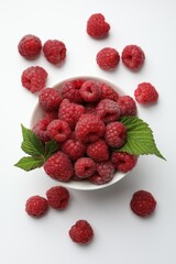 Tasty fresh ripe raspberries and leaves on white background, flat lay