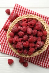 Tasty fresh ripe raspberries on white wooden table, flat lay