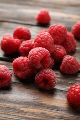 Tasty fresh ripe raspberries on wooden table, closeup