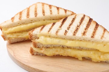 Tasty sandwiches with melted cheese on white table, closeup
