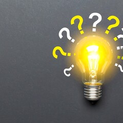 Illuminated lightbulb with question marks