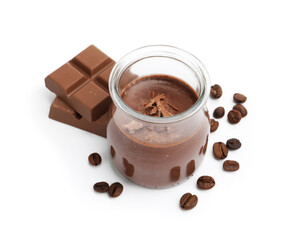 Delicious chocolate panna cotta in glass jar, coffee beans and chocolate pieces isolated on white