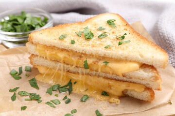 Delicious sandwiches with melted cheese and parsley on table, closeup