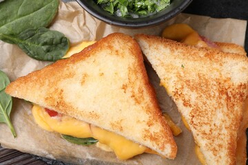 Delicious sandwiches with melted cheese and spinach on table, flat lay